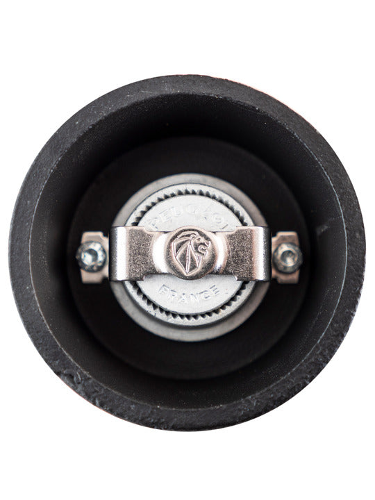 Peugeot | Bali Cast Iron Pepper Mill, Black, showcasing its intricate grinding mechanism with a central adjustment knob featuring a lion logo and France inscription.