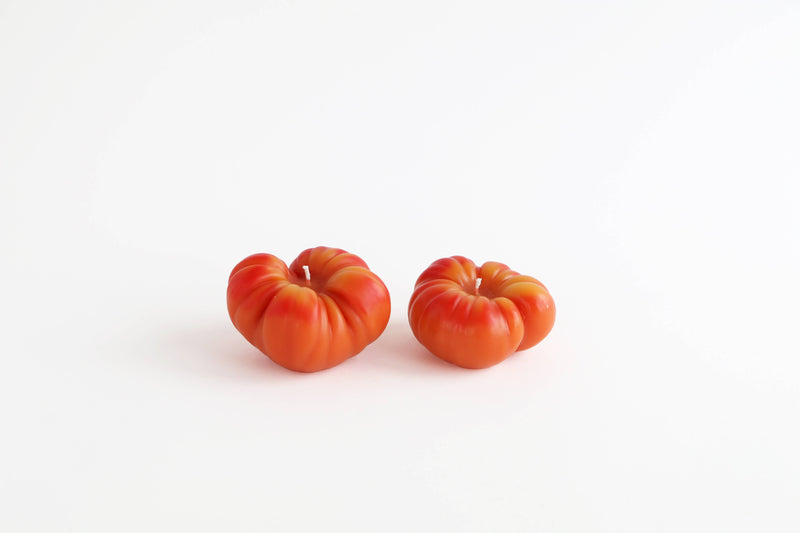 Artifaqt - Heirloom Tomato Beeswax Candle: Green / Small, shaped like a tomato, displayed on a white surface, highlighting its unique and eco-friendly design.
