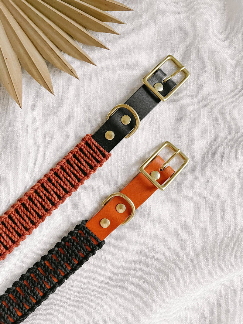 EMBER & IVORY - Black/Rust WIDE Leather & Macrame Collar: Small, features leather and rust-red macramé with brass hardware, displayed on a fabric background with a decorative leaf.