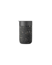 W&P - Reusable Ceramic Mug: Terrazzo Blush with a black, splash-resistant lid and non-slip silicone sleeve, ideal for sustainable morning beverages.