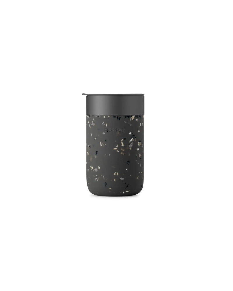 W&P - Reusable Ceramic Mug: Terrazzo Blush with a black, splash-resistant lid and non-slip silicone sleeve, ideal for sustainable morning beverages.