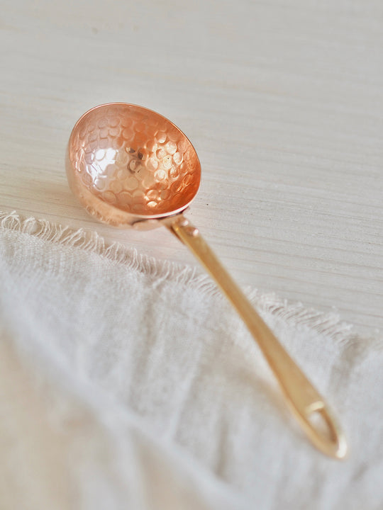 Be Home | Camden Scoop: Handcrafted copper spoon with a unique rippled texture, perfect for adding rustic elegance to any kitchen setting.