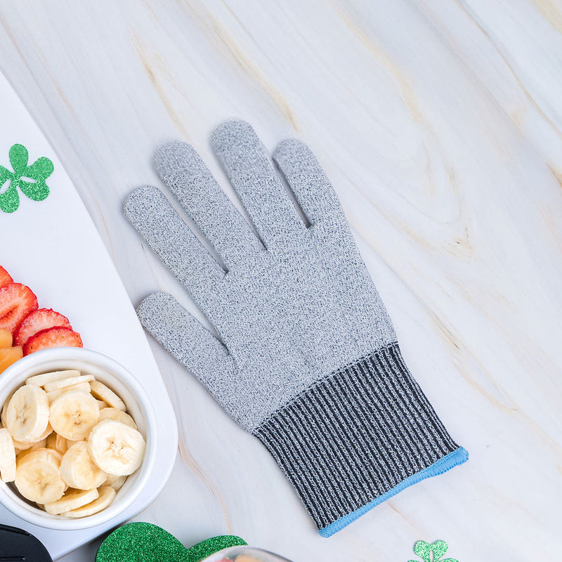 Microplane | Cut Resistant Kitchen Safety Glove on a surface, near a tray with banana and strawberry slices, ideal for safe food prep in kitchens.