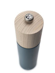 Peugeot | Boreal Pepper Mill, Celestial Blue features a natural wood top and dark body, topped with a metal knob bearing a lion's-head logo.
