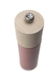 Peugeot | Boreal Pepper Mill, Hazelnut: A tall, cylindrical grinder with a natural wood top and pinkish-red body, featuring a metal knob with P and lion logo.