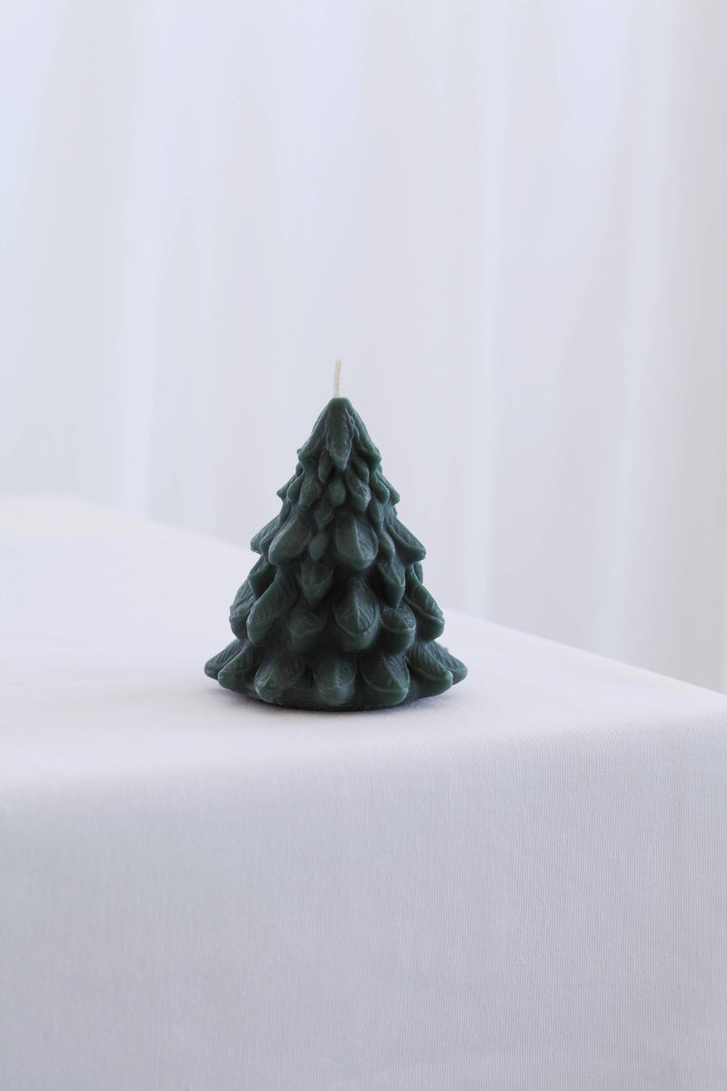 Mo&Co Home exclusive small dark-green beeswax candle shaped as a stylized pine tree, showcasing intricate branch details, perfect for adding elegance to holiday settings.