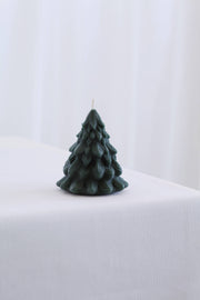 Mo&Co Home Exclusive: Small green beeswax candle sculpted as a pine tree, unlit, showcasing intricate design inspired by vintage ornaments and holiday nostalgia.