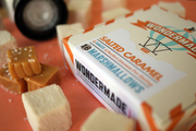 Wondermade Salted Caramel Marshmallows box with marshmallows and salted caramel pieces scattered around, highlighting a specialty food item from Athens Cooks' curated selection.