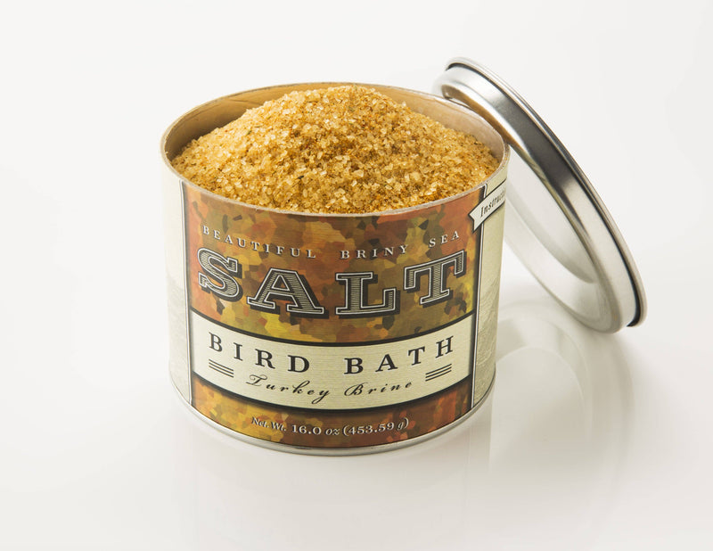 Beautiful Briny Sea - Bird Bath Turkey Brine in an open tin, showcasing coarse, amber-colored salt. Perfect for seasoning meats, vegetables, and more. 16 oz.