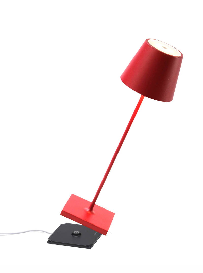 Zafferano America - Poldina Pro Cordless Lamp: Rust, features a sleek red design with a magnetic black base and adjustable LED shade for versatile indoor/outdoor use.