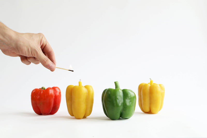 Artifaqt - Bell Pepper Beeswax Candle: Green, depicted as a green bell pepper being lit, showcasing its unique design inspired by natural produce.