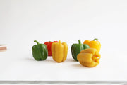 Artifaqt - Bell Pepper Beeswax Candle: Red, shaped like a vibrant bell pepper, displayed on a white surface, highlighting its unique design and natural beeswax material.