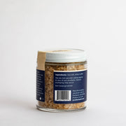 Jacobsen Salt Co. - White Truffle Salt - Infused Sea Salt in a small glass jar, highlighting its use for enhancing beef, asparagus, and popcorn flavors.