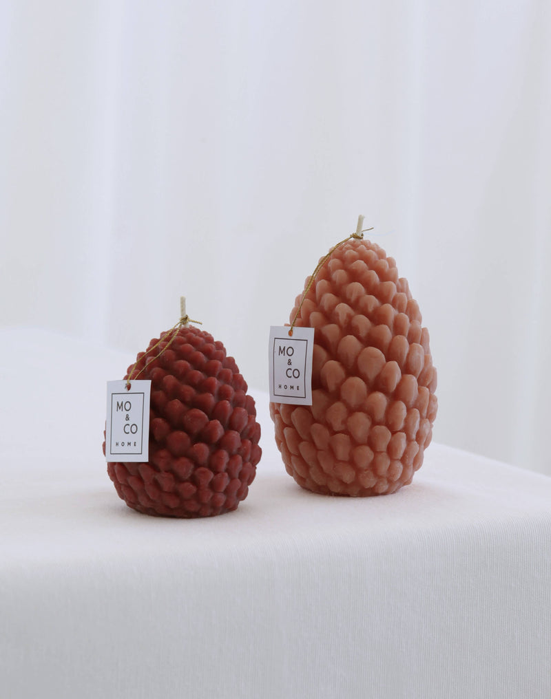 Mo&Co Home Exclusive: Sculpted Beeswax Pine Cones, hand-poured, featuring intricate pine-cone shapes in two sizes, perfect for adding elegance to holiday gatherings.