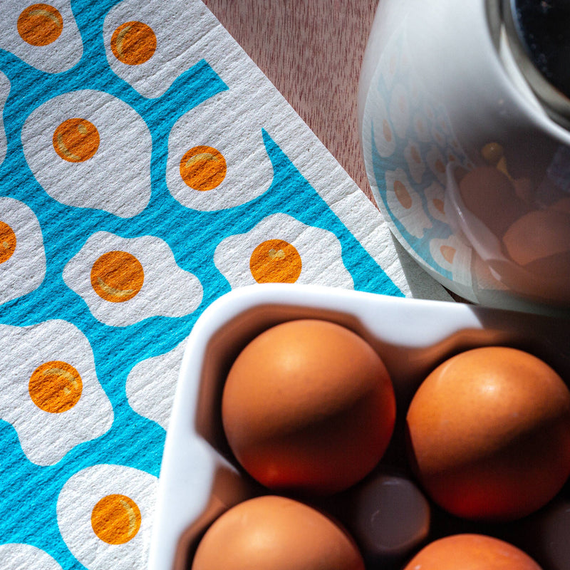 Bespoke Provisions - Eggs Swedish Dishcloth on a table, highlighting its eco-friendly design for cleaning, part of Athens Cooks' curated kitchen tools.