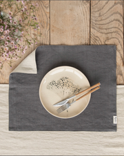 MagicLinen - Double Layer Linen Placemat Set of 2 in charcoal grey, featuring a fork and knife on a plate, highlighting its stylish table setting use.