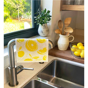 Bespoke Provisions - Lemons Swedish Dishcloth next to a kitchen sink, perfect for cleaning countertops and dishes, eco-friendly and biodegradable.