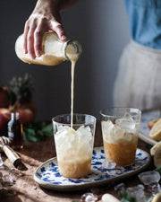 Farmhouse Pottery - Farmhouse Glasses: Set of 6 - Small, shown with a frothy iced beverage, highlighting their versatile, luxurious borosilicate glass design.