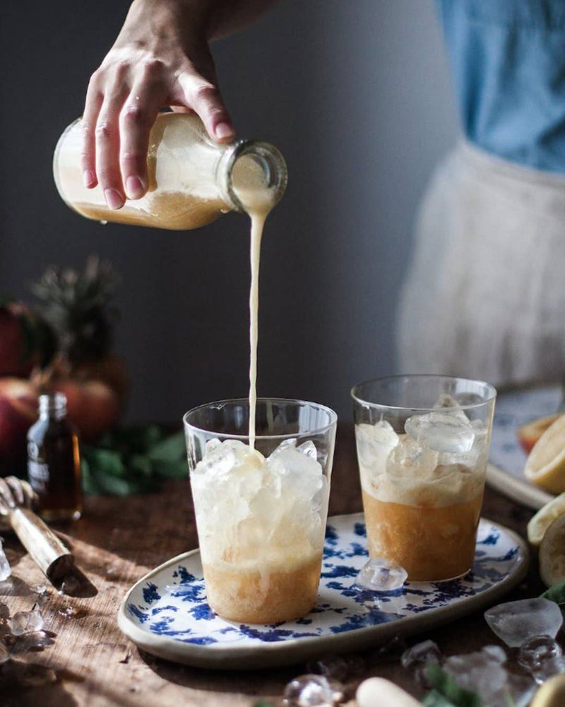 Farmhouse Pottery - Farmhouse Glasses: Set of 6 - Small, shown with a frothy iced beverage, highlighting their versatile, luxurious borosilicate glass design.