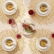 Chilewich | Bloom Placemats - Champagne elegantly displayed on a dining table with bowls of soup and glasses, showcasing its intricate floral openwork design.