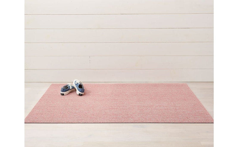 Chilewich Heathered Shag Mats - Blush, 18 x 28, displayed on a pink mat, showcasing its durable and stain-resistant texture suitable for various home spaces.