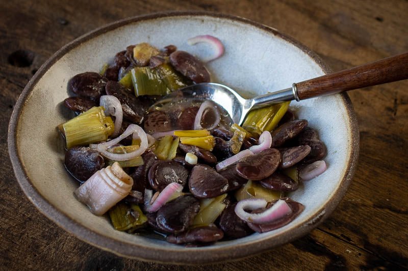A bowl of Christmas Lima Bean mixture with a spoon, highlighting Rancho Gordo's specialty product, available at Athens Cooks.