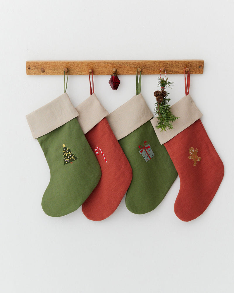 MagicLinen | Gingerbread Man Embroidered Christmas Stocking hanging on a peg rail, showcasing festive embroidery, part of a sustainable, zero-waste holiday decor collection.