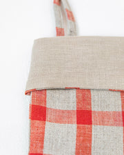 MagicLinen's handcrafted linen Christmas stocking in clay red, featuring a double-layer design with a hanging loop, embodies sustainable holiday decor.