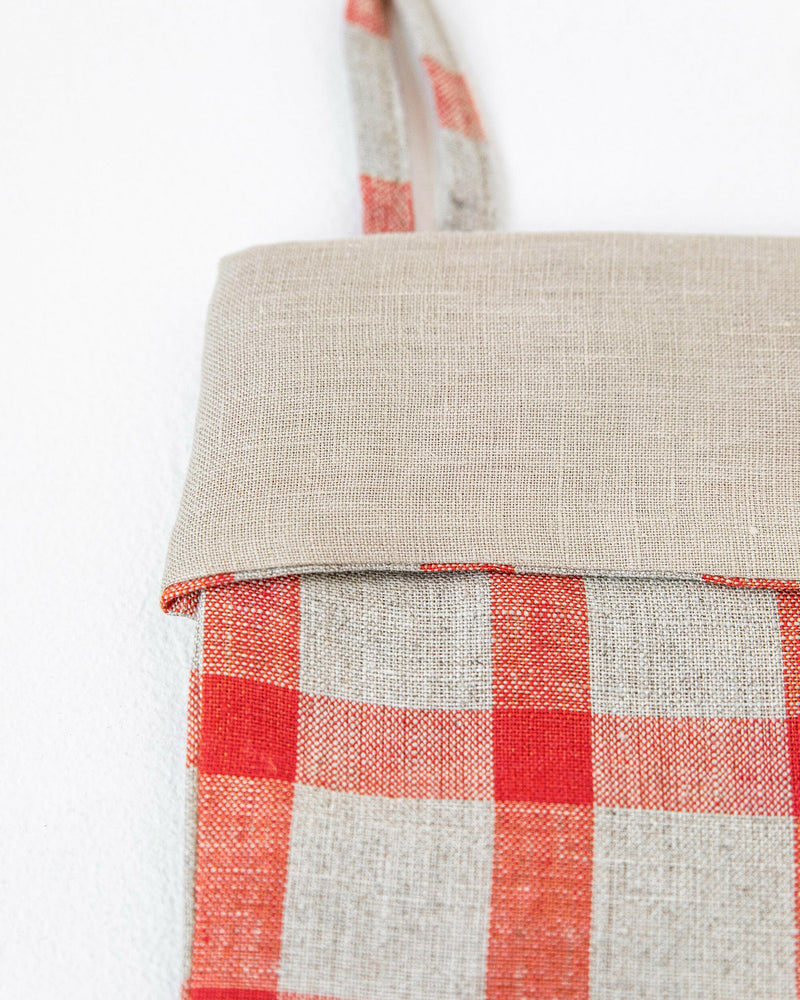 MagicLinen's handcrafted linen Christmas stocking in clay red, featuring a double-layer design with a hanging loop, embodies sustainable holiday decor.