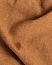 MagicLinen forest green linen tablecloth, 59x98 inches, with a simple seam finish, ideal for versatile dining settings, available at Athens Cooks kitchen store.