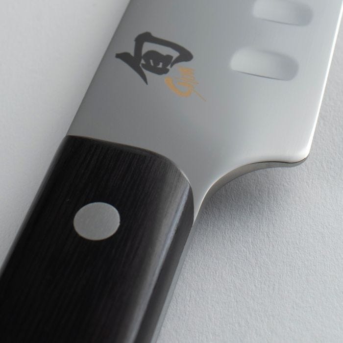 Shun Classic Hollow Ground Brisket Knife, 12 inches, with polished blade featuring granton dimples and kanji logo, riveted handle, ideal for precise meat slicing.