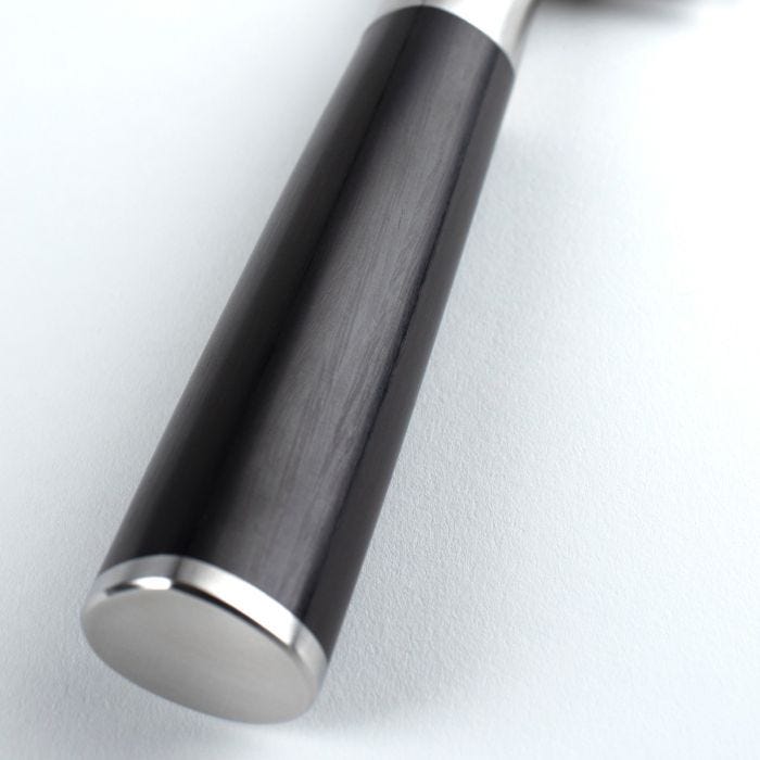 Shun | Classic Hollow Ground Santoku, 7 inches, features a D-shaped wood-grain handle with visible metal cap and part of the blade, ideal for versatile kitchen use.