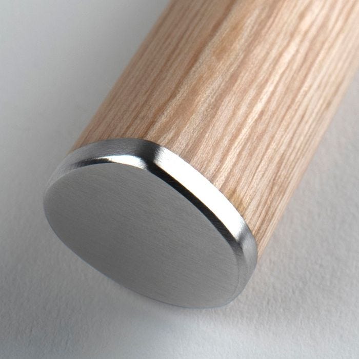 Close-up of the Shun Classic Blonde Santoku's wooden handle with brushed stainless-steel cap, showcasing its elegant craftsmanship and premium materials.