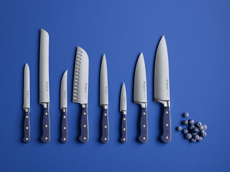 Wüsthof Classic 8-Piece Designer Knife Block Set featuring close-ups of knives, ideal for culinary precision, showcased among blue decorative balls.
