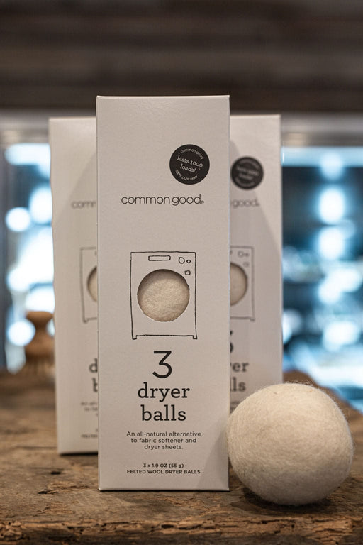 Common Good | Dryer Balls, Box Set of 3 on a wooden surface, showcasing an eco-friendly, natural laundry alternative from Athens Cooks.
