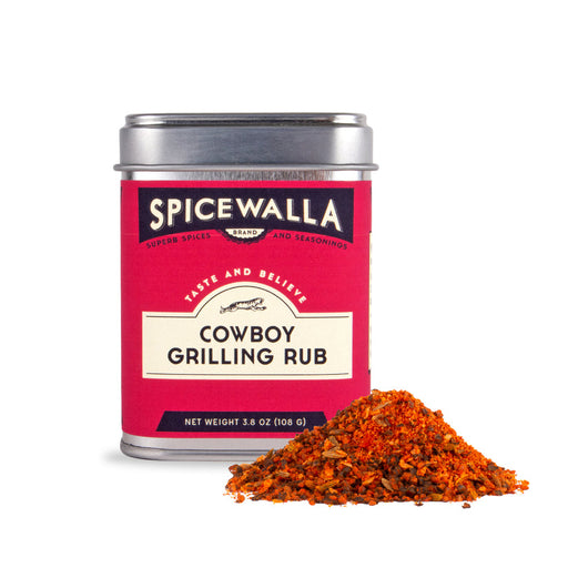 Spicewalla | Cowboy Grilling Rub tin with spilled spice blend, featuring black pepper, garlic, and smoked paprika, ideal for enhancing grilled dishes.