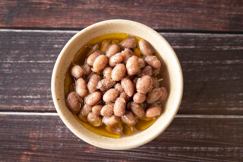 Rancho Gordo | Cranberry Bean in oil, presented in a bowl, highlighting their rich texture and culinary versatility, ideal for gourmet cooking.