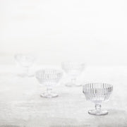 Fortessa | Archie Clear 10oz Footed Dessert Bowl with molded facets, showcasing elegant design and light refraction, ideal for stylish tablescapes. Dishwasher safe, not microwave or oven safe.