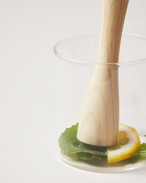 Farmhouse Pottery - Craft Pantry Muddler pressing lemon and mint in a glass, showcasing its rustic Ash wood design, ideal for crafting cocktails.