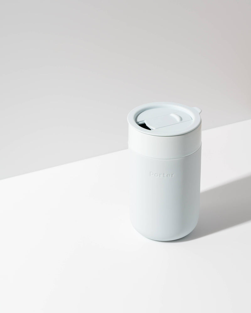 W&P - Ceramic Reusable Coffee Mug 16oz: Charcoal, featuring a white lid and silicone sleeve, designed for durability and style, perfect for eco-conscious coffee lovers.