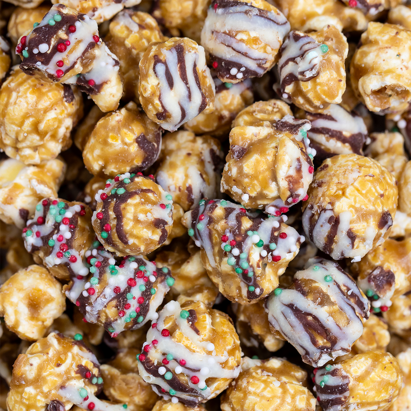 Poppy Hand-Crafted Popcorn - Christmas Confetti Popcorn, featuring caramel-coated popcorn drizzled with chocolate and festive sprinkles, ideal for holiday gifting and seasonal displays.