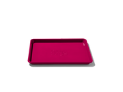 Great Jones | Little Sheet - Pepper, a compact, nonstick quarter-sized baking tray, ideal for small batch baking and reheating, showcased on a dark background.