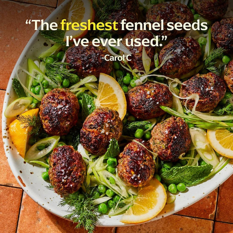 Diaspora Co. Spices - Hariyali Fennel on a plate with lemon slices and meatballs, highlighting its fresh aroma and culinary versatility.