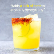 Diaspora Co. Spices - Guntur Sannam Chilli in a glass, garnished with a lime slice, highlighting sustainable farming and unique spice blend from Guntur, India.