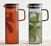 HARIO USA - HARIO Colors Glass Cold Brew Pitcher, 800ml: Grey, featuring amber and clear glass versions with fruit tea and lime-mint infused water.