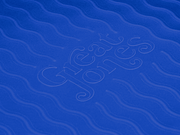 Great Jones | Patty Cake - Broccoli with wavy, corrugated bottom for easy release, showcased on a blue abstract fabric pattern.