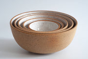 RachaelPots - Nesting Bowls Set Of Five: Light Blue, showcasing a stack of speckled stoneware bowls with hand-trimmed bases, ideal for diverse culinary uses.