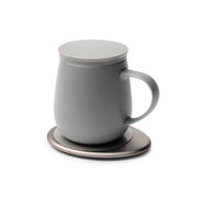 OHOM - Ui 3 Self-heating Mug Set: Jasmine White, showcasing a matte-gray mug on a metallic charging coaster, designed to maintain optimal beverage temperature and wirelessly charge devices.