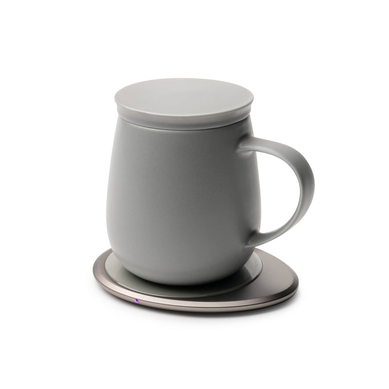 OHOM - Ui 3 Self-heating Mug Set: Soft Gray, shown with its electric warming plate and lid, ideal for maintaining beverage temperature and wirelessly charging phones.