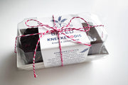 Norwegian Baked - KnekkeGodis, a sweet Nordic cookie toffee bark in a neatly tied white package with red and white string, perfect as a gift.